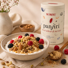 Panjiri over yogurt with berries beside the WOMENT tin